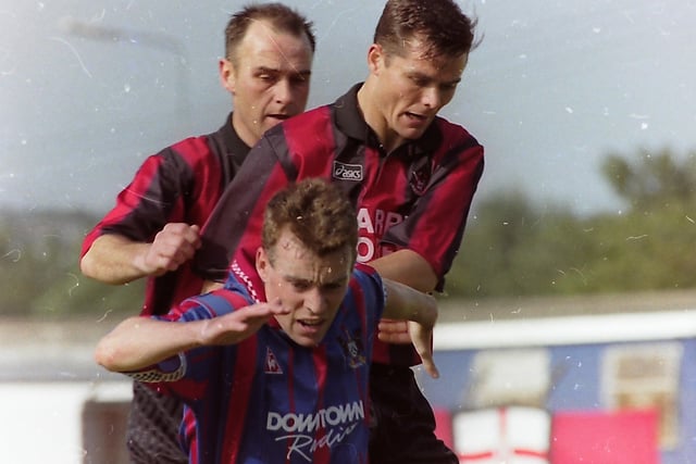 A Crusader player tries to push an Ards player off the ball during the Ards v Crusaders match at Castlereagh Park, Newtownards, in September 1996, in the Gold Cup