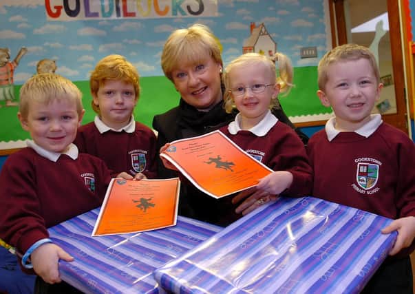 St Marys Grammar School Vice-Principal Mrs O'Brien with pupils from Cookstown Primary School Adam, Stuart, Kristyn and Jack winners of the colouring Inn competition ran in association with St Marys production of 'Oliver'.The School would also like to celebrate the involement in the play by pupil Kristyn Cuddy.mm48-340sr