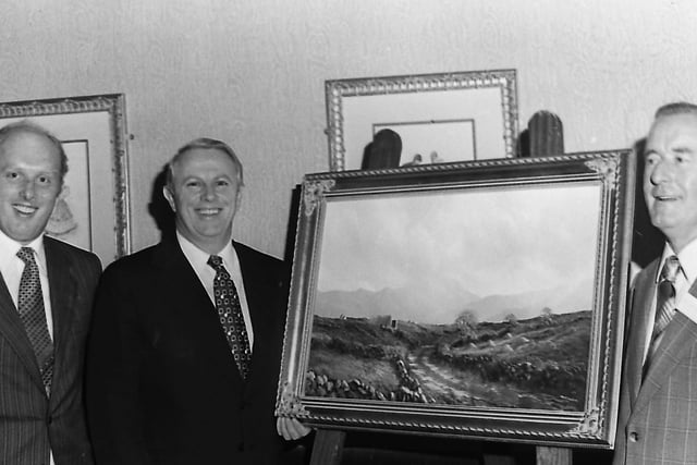 Mr Joe Malone, director general of Bord Failte, presents a painting of the west of Ireland to Mr Don Faughnan, who had just retired as the Northern Ireland manager for Bord Failte after 39 years service. Mr Graeme Allen, the new manager, is to the left. Picture: News Letter archives