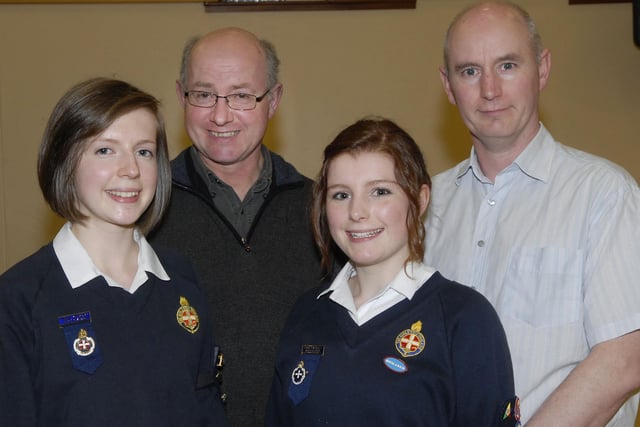 Rachel Longwell, left, and Ruth Bunting who were presented with their Brigader Brooches by their proud dads, Robert Longwell, second from left, and Ian Bunting, at the annual Inspection & Display held on Thursday night by 320th Kilfennan Girls' Brigade. LS18-151KM10