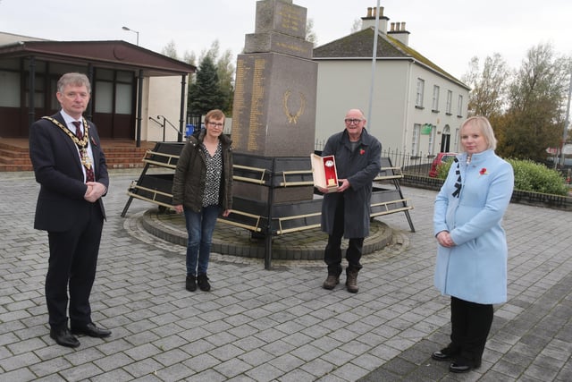 John Boyd and Christine Hodges pictured at Limavady War Memorial as they accept a silver Poppy of Remembrance on behalf of their late father Royal Navy Able Seaman Maurice Boyd who passed away earlier this year from the Mayor of Causeway Coast and Glens Borough Council Alderman Mark Fielding and Veterans’ Champion Councillor Michelle Knight McQuillan