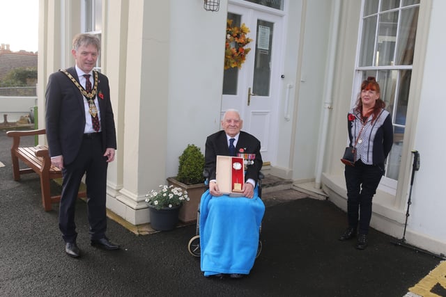 Royal Air Force Flight Lieutenant Geoff Bainbridge pictured with his silver Poppy of Remembrance, alongside his daughter Lorna Gough and Mayor of Causeway Coast and Glens Borough Council Alderman Mark Fielding