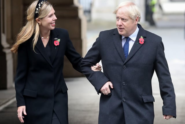 Prime Minister Boris Johnson with partner Carrie Symonds, on their way to meet veterans, following the National Service of Remembrance at the Cenotaph, in Whitehall, London. PA Photo. Picture date: Sunday November 8, 2020. See PA story MEMORIAL Remembrance. Photo credit should read: Chris Jackson/PA Wire