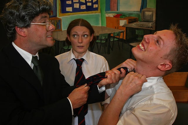 The cast from the drama 'Fair Faa Ye', (from left), Darren Greer (teacher), Sorcha Shanahan (Lizzie) and Alan Wright (Adam Finlay), in a scene during the "oot an aboot", programme with the  Foyle Ulster- Scots Festival held in the Fountain Primary School in Londonderry .