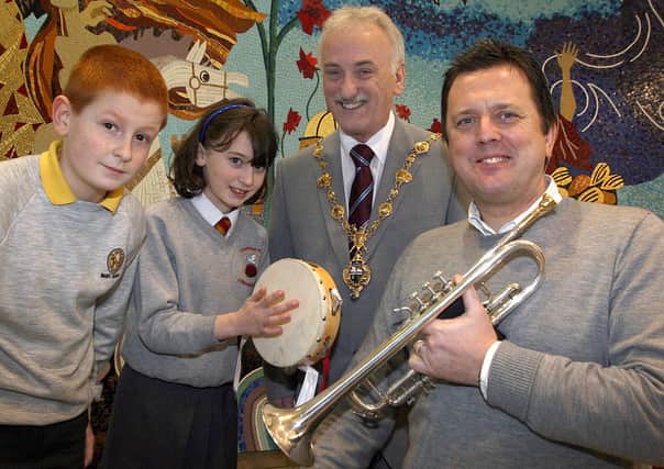 The Mayor of Londonderry Alderman Drew Thompson, who opened the 'Musical Magic', concert in The Millennium Forum with the help of Paul Young, trumpet player with the Ulster Orchestra and pupils Aaron Quigley, Model PS and Rachel Hepburn, Fountain PS. Musical Magic is an education project developed by the Ulster Orchestra's education department to introduce 7-11 year olds to the instruments of the orchestra. LS05-530MT.