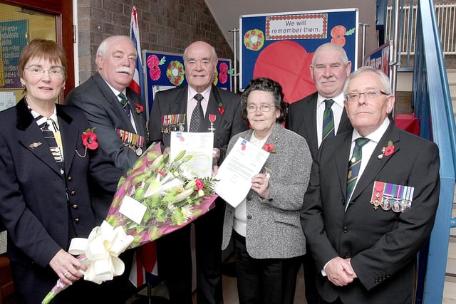 Deputy Lord Lieutenant for the City of Londonderry David Davis (second from left), presents certificates to William Loughlin and Mamie Rosborough, in recognition of their 40 years as poppy sellers, at the Armistice Day service in The Fountain Primary School.  Included (from left) are Isobel McNally, school principal, Hugh McNaughton, vice-president, Royal British Legion, Londonderry Branch and James Baird, secretary.  lS47-524MT.