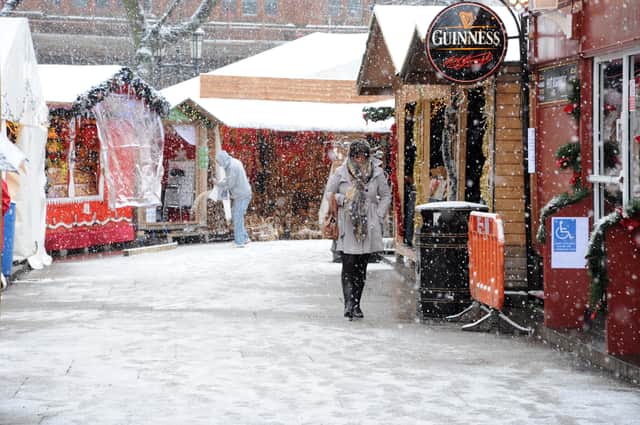 3rd December 2010
Shoppers  in Belfast battle thru the snow in the City Centre's Continental market.