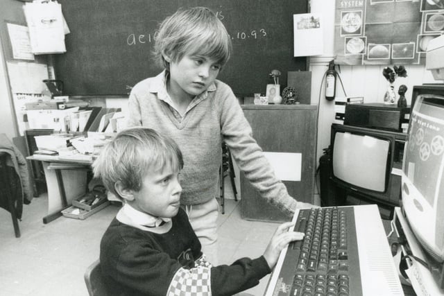 Keeping an eye on the latest learning aids in 1993 are Rathlin Island schoolchildren James McFaul and Fergus McFaul. Picture: Northern Ireland Electricity/News Letter archives