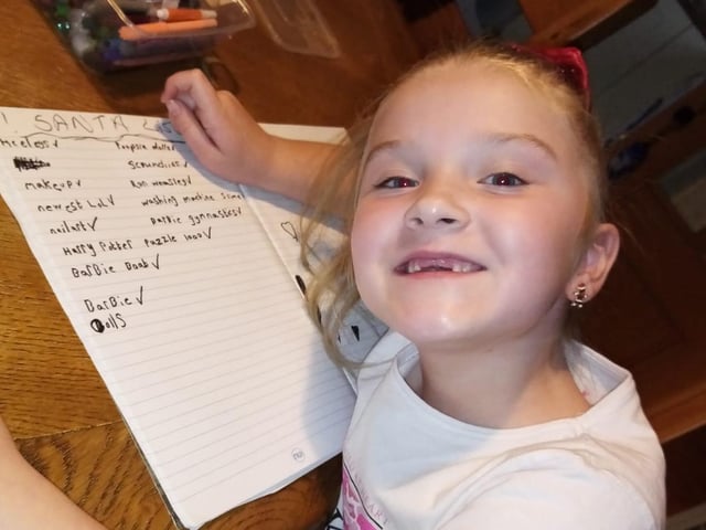 Faela Murphy writing out her Santa list.