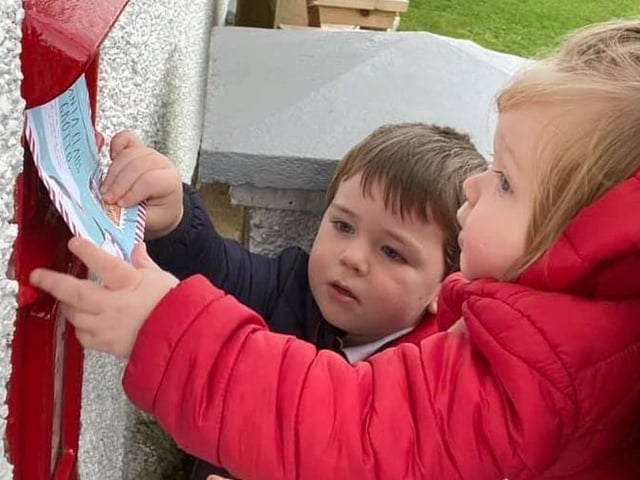 Harry and Dylan Mackey posting their letters to Santa.