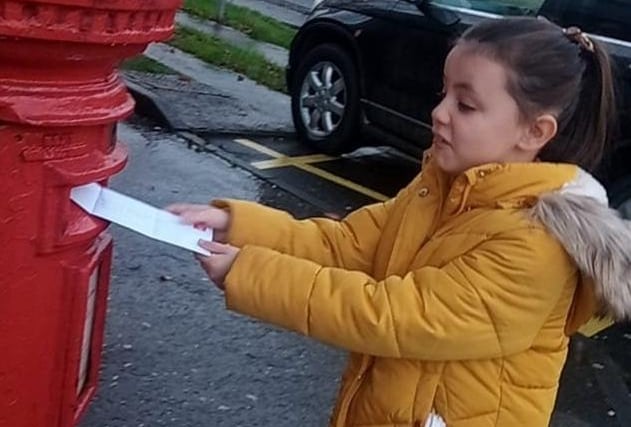 Alicia Nash posting her letter to Santa