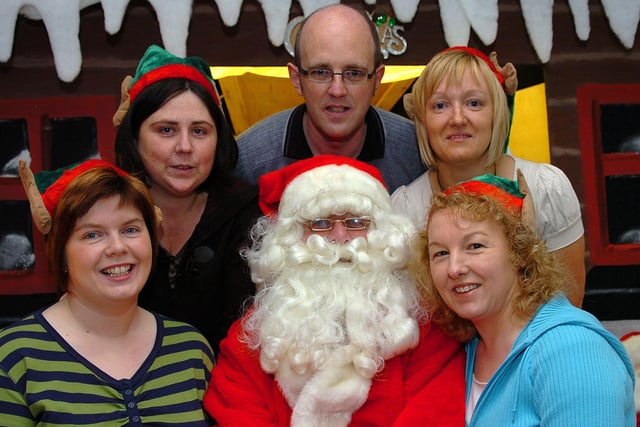 Santa Claus who was the guest of honour at the 'Breakfast With Santa' event held at Coagh Primary School last Saturday morning surrounded by the committee of the school's Parent Support Group.mm51-374sr