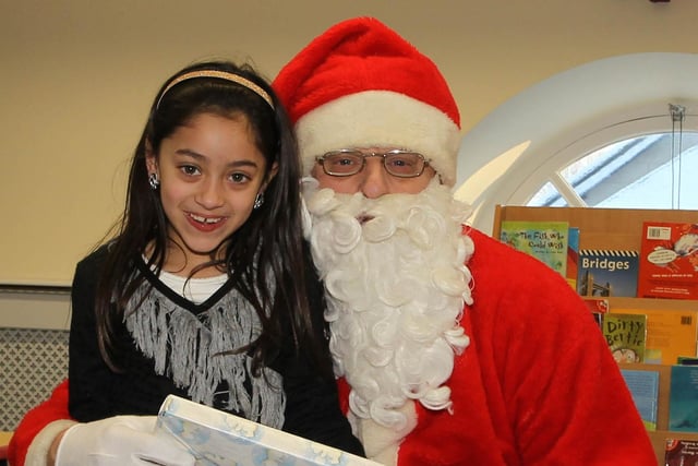 Ayesha Darragh of Gracehill After Schools Club gets a present from Santa during his visit to the club last week