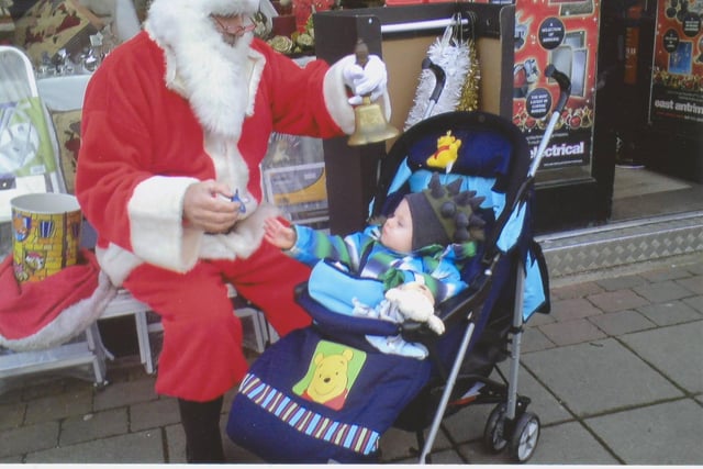 Santa giving out sweets outside East Antrim Electrical