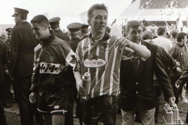 Liam Coyle who won the Opel Soccer Writers' Personality of the Year and the PFAI Player of the Year award in 1995, makes his way up to lift the trophy.