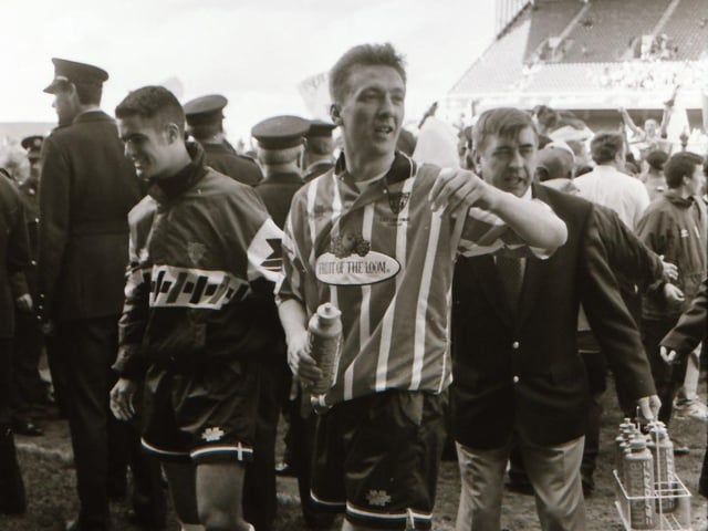 Liam Coyle who won the Opel Soccer Writers' Personality of the Year and the PFAI Player of the Year award in 1995, makes his way up to lift the trophy.