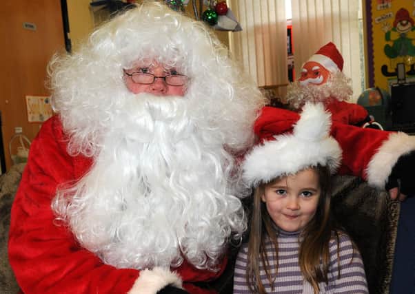 Ellie visits Santa at the 'Breakfast with Santa' at Coagh Primary School last Saturday morning.mm51-125ar.