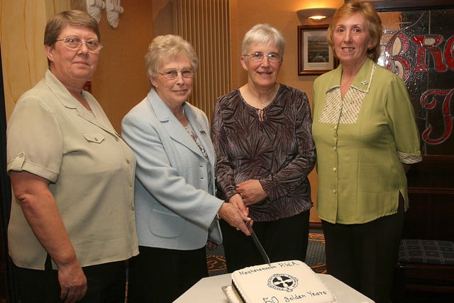 Catherine Kincaid (third from left), president of Magheramason WI and Lorna McNeely, vice-president, cutting the cake to mark the WI's 50th anniversary, at a special dinner held in The Broomhill Hotel.  Included are Frances (left), treasurer and Helen Walker, secretary. LS46-536MT.