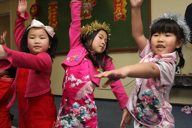 Yugi, Anna and Keke, perform a dance for the audience at the Chinese 2010 New Year celebration party, held at the Chinese Language and Cultural School, organised by the Londonderry Mandarin Speakers Association. LS0610-505MT.