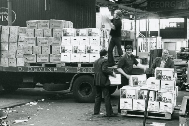 Loading boxes of apples at St George's Market in September 1975. The men loading the apples were from Devines Fruit Importers. Picture: News Letter archives