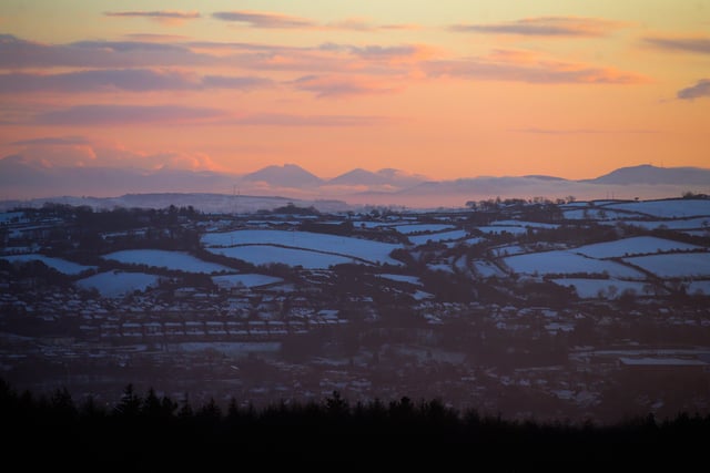 The Mourne Mountains in the distance, as seen from the Craigantlet Hills in Co. Down, as the sun goes down over Belfast on a cold January Sunday. 

Picture by Jonathan Porter/PressEye