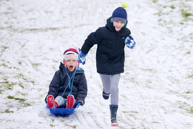 Seven-year-old Ciaran and 11-year-old Ollie enjoy the snow at Stormont in east Belfast. 

Picture by Jonathan Porter/PressEye