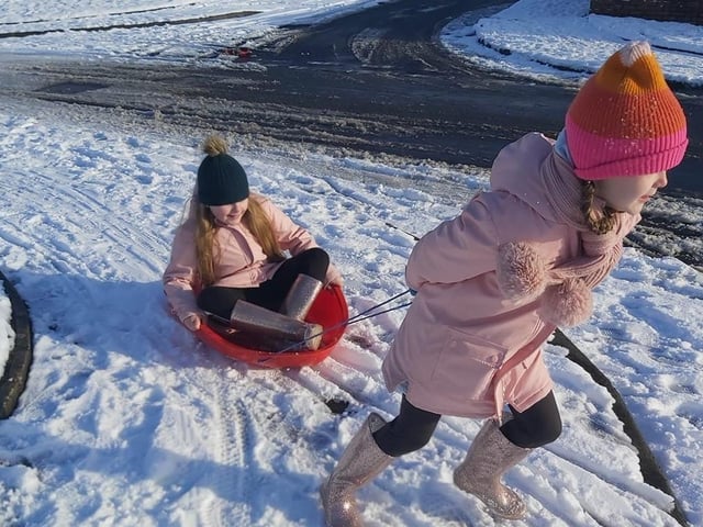 Caroline Caz  -Sisters Lucy and Sophie taking turns pulling each other in the sleigh.