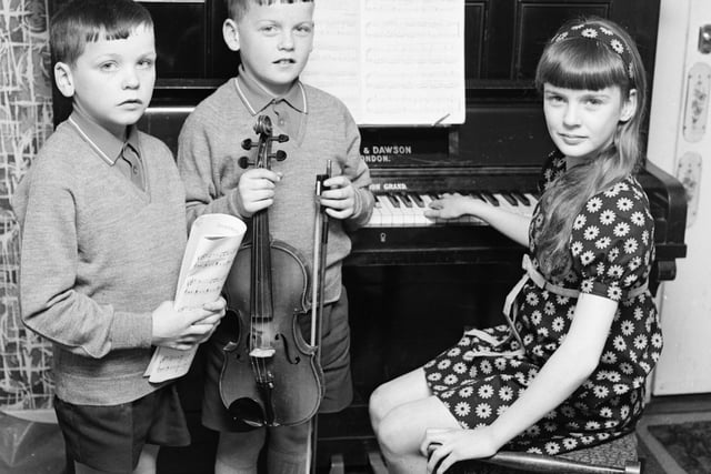 1969... Eleven years old Anne McCloskey won both the junior piano (10-12 years) and girls' vocal solo (10-12 years) competitions at Feis Doire Colmcille. She's pictured here with her brothers, John (10), on left, who was among the bursary award winners in the violin classes, and Francis (9), who was a third prizewinner in the violin (under 10 years).