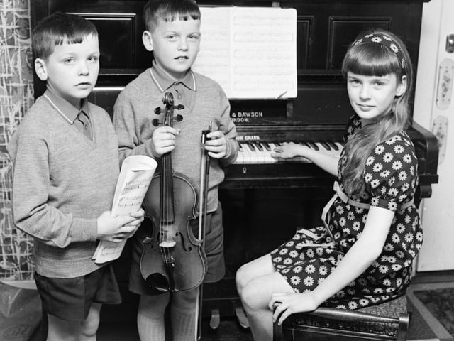 1969... Eleven years old Anne McCloskey won both the junior piano (10-12 years) and girls' vocal solo (10-12 years) competitions at Feis Doire Colmcille. She's pictured here with her brothers, John (10), on left, who was among the bursary award winners in the violin classes, and Francis (9), who was a third prizewinner in the violin (under 10 years).