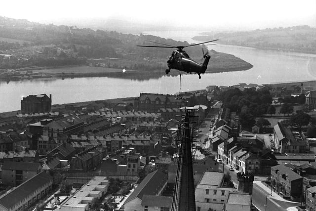 1980... The British Army helps place a cross on the spire of St Columb's Cathedral.