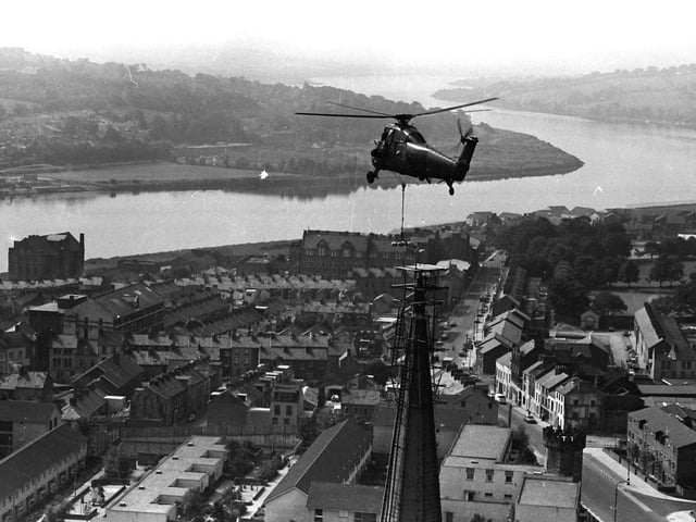 1980... The British Army helps place a cross on the spire of St Columb's Cathedral.