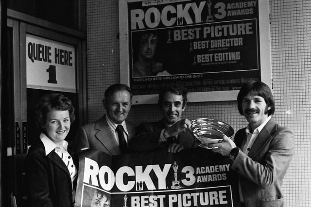 1977... Special guests of the management of the Strand Cinema at the first showing in Derry of the film, 'Rocky', which won three Oscars, were boxer Charlie Nash and his wife, Betty. George Arrow, manager of the cinema, presents Charlie with a piece of Ulster pewterware to mark the occasion. Included is James McCauley, director, Strand Cinema.