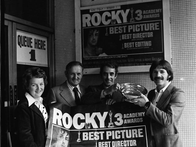 1977... Special guests of the management of the Strand Cinema at the first showing in Derry of the film, 'Rocky', which won three Oscars, were boxer Charlie Nash and his wife, Betty. George Arrow, manager of the cinema, presents Charlie with a piece of Ulster pewterware to mark the occasion. Included is James McCauley, director, Strand Cinema.