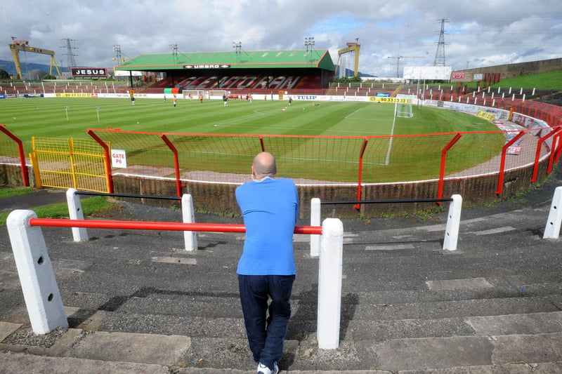 A lone Glentoran fan watches his team train as the opening round of fixtures was postponed due to a referees' strike