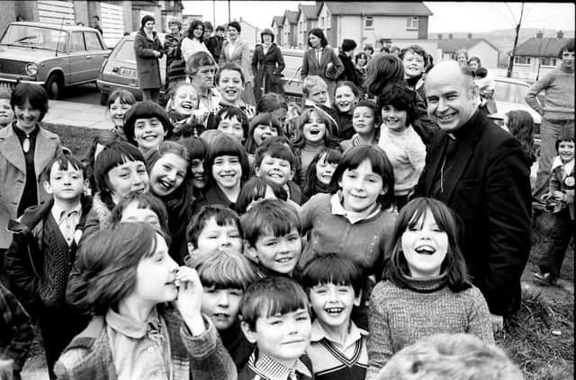 April 1980... Bishop of Derry, Dr Edward Daly, pictured with a group of kids during a pastoral visit to the Top of the Hill in the Waterside.