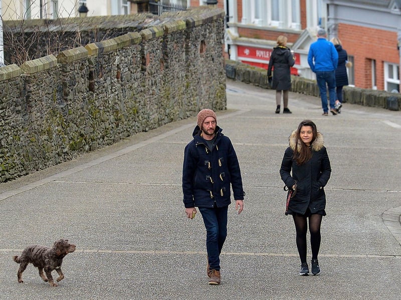 People walk along Derry’s Walls recently. DER2106GS –