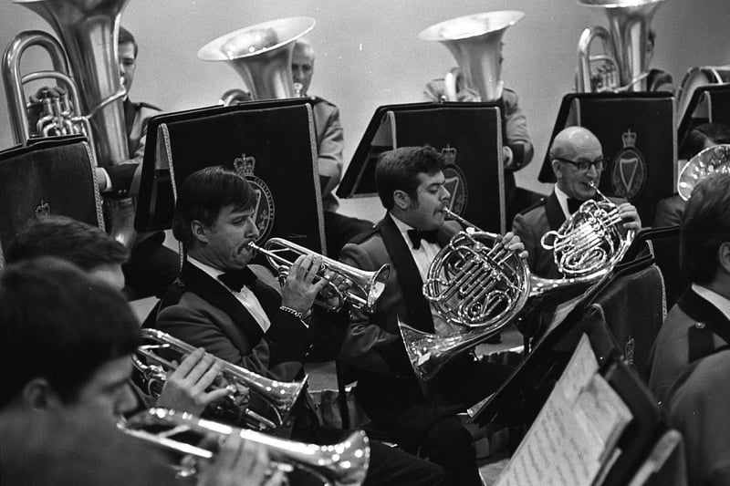 Police musicians got into the swing of things in February 1982 when they paraded in new uniforms fore the first time. The special concert by the band of the Royal Ulster Constabulary marked the start of the organisation's Diamond Jubilee celebrations. The new concert uniform was modelled on the RUC officers' mess dress. It had a red body and sleeves with black shawl collar, black rifle cuffs and black epaulettes. The finishing touches included white shirts, bow ties, green cumberbunds and black braided trousers. Women members wore white blouses and long black shirts. The programme for the concert at the Garnerville complex in Belfast had been selected by Superintendent Andrew Forbes, director of music of the band. Pictured above, the RUC band wearing new concert uniforms at the special concert held at RUC Garnerville in February 1982. Below, trombonists Christine Murphy, right, and Valerie Trimble, were the only women in the RUC band at that time. Pictures: News Letter archives