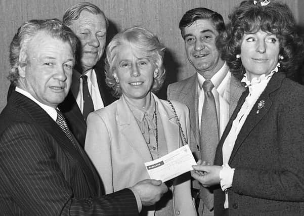 Billy Bingham presenting a cheque for £100,000 to Lady Dunleath, president of the Northern Ireland Council for Orthopaedic Development in February 1982. Included are Mr Jimmy James, chairman of NICOD, Mrs Thelma Greeves, organising secretary of NICOD, and Mr George Abbott from Bristol. Picture: News Letter archives