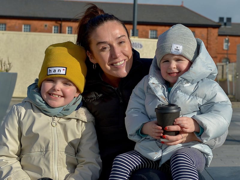 Farrah, aged 6, and Cassie (2) Murray enjoying the sunshine in Ebrington Square recently with their mum Martina. Photos: George Sweeney / Derry Journal. DER2107GS – 008