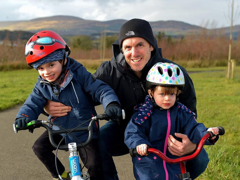Aodhan, aged 5 and Eva O’Donnell (3) pictured with their dad Niall getting some exercise in Culmore Country Park recently. DER2107GS – 003