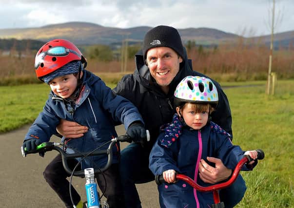 Aodhan, aged 5 and Eva O’Donnell (3) pictured with their dad Niall getting some exercise in Culmore Country Park recently. DER2107GS – 003