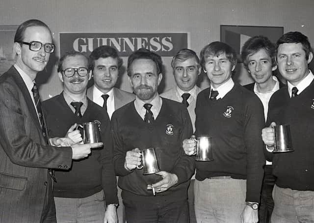Mr John Kinahan, left, marketing manager, Arthur Guinness (Belfast) handing over trophies to the Holywood Yacht Club team which won the Guiness Inter-Pub/Club Charity Quiz, run in association with the Holywood Round Table. The team beat the Holywood Social Club in the district final. In the picture are Norman Bennett, captain, Austin Treacy, Tom Smeltzer and John Bingham. Also included are John Galbraith, scorer, Roy Williams, questionmaster, and Geoff Hunt, timekeeper. Picture: News Letter archives