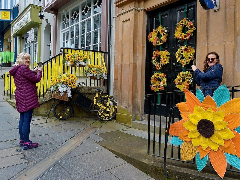 Veritas Bookshop employees Geraldine Carlin and Marie Brown take a snap of the St Patrick’s Day artwork outside the bookshop on Shipquay Street. DER2110GS – 007