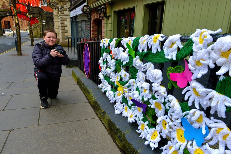 Young photographer Christopher Gillen, aged 11, photographs some of the crocheted artwork on Shipquay Street celebrating St Patrick’s Day.Photo: George Sweeney  DER2110GS – 001