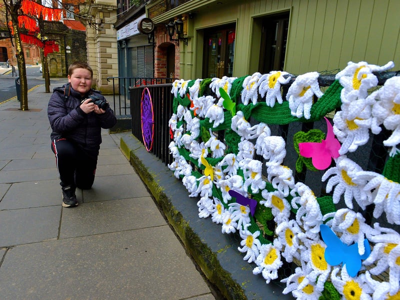Young photographer Christopher Gillen, aged 11, photographs some of the crocheted artwork on Shipquay Street celebrating St Patrick’s Day.Photo: George Sweeney  DER2110GS – 001