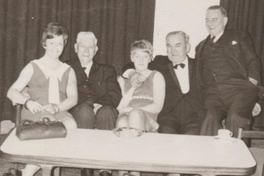 This old photo from Gareth Jones' time at the King's Arms Hotel in 1967-68 features (fourth from left) Paddy Avington,  tour guide.  
"Sitting on the arms of the seat is a regular customer Captain Green," said Gareth. "I recognise the white-haired gentleman, but for the life of me I can’t remember his name, I think he either worked at head office (McNeill's) or he was possibly a director of the company."