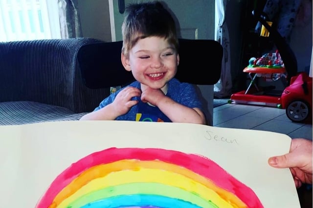 Sean McParland age 4 and his painting of a rainbow. He has complex medical needs so he needed his mummy to help him hold the brush to paint it out!