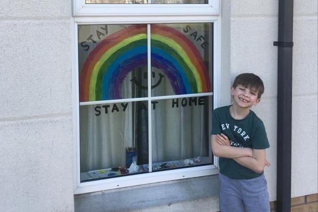 Sam Cranston proudly shows off the rainbow he painted with his mum Claire