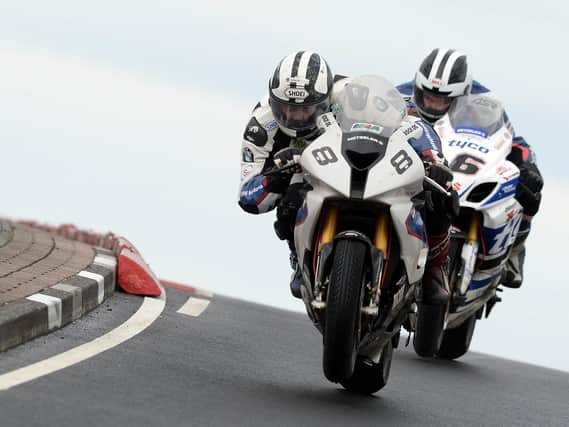 Michael Dunlop (Hawk BMW) leads William Dunlop (Tyco Suzuki) on the final lap of the opening Superbike race at the North West 200 in 2014.
