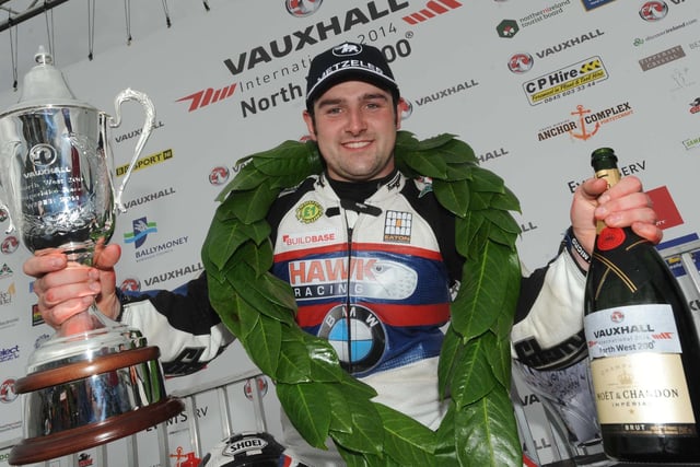 Michael Dunlop with the victory spoils following his win in the NW200 Superbike race - his first in the premier class at the Triangle road race.